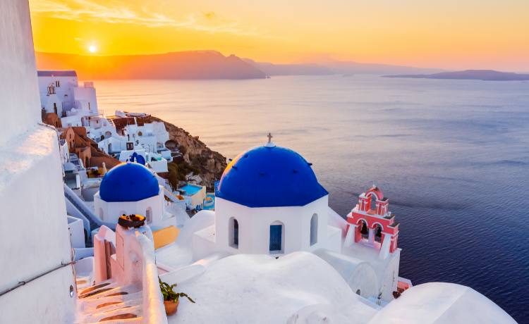 The wonderful Oia Santorini Blue Domes with Sunset in the Backdrop